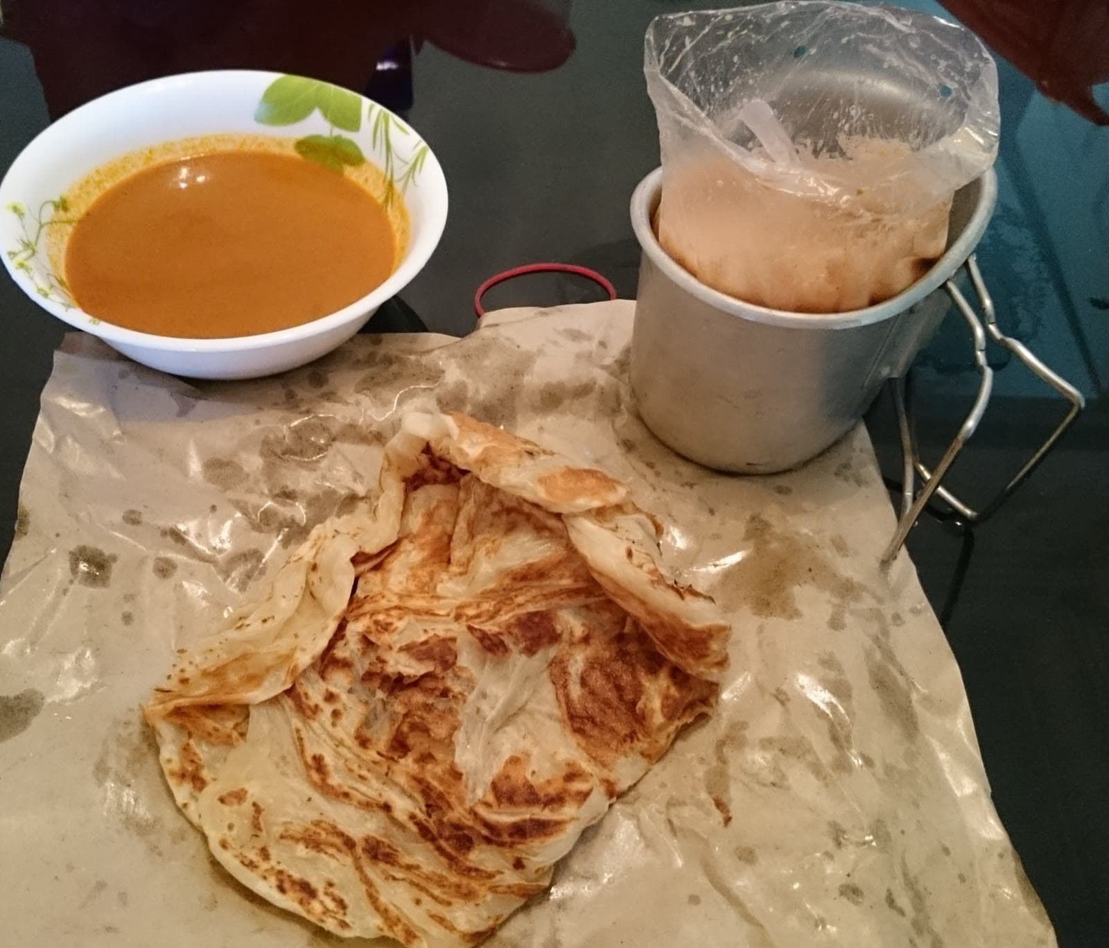 Roti prata served with curry and tea